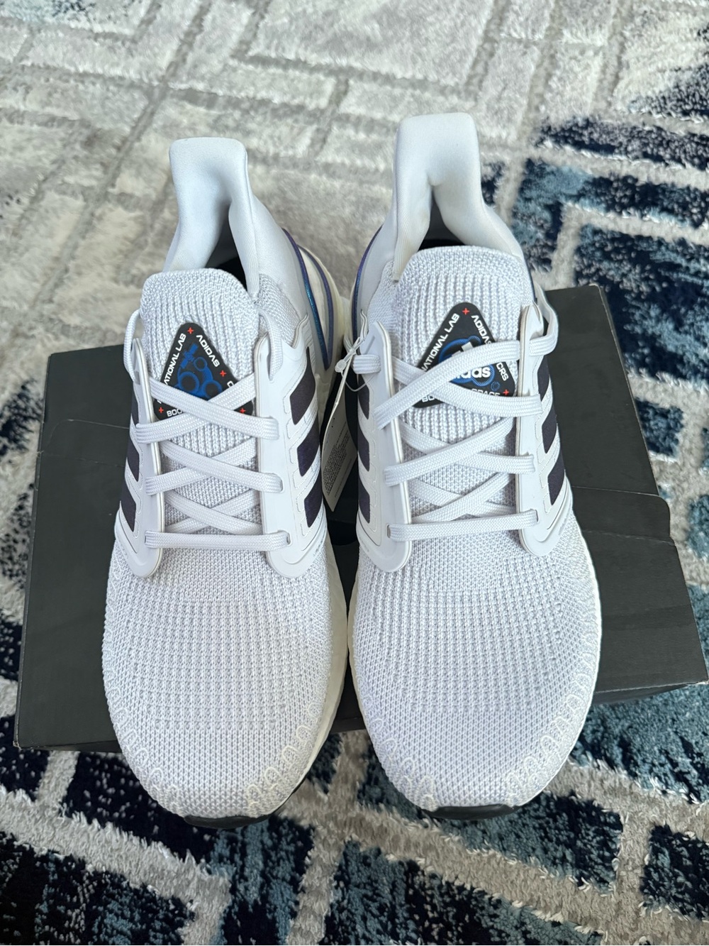 adidas White Knit Sneakers with Black Stripes and Subtle Blue Accent